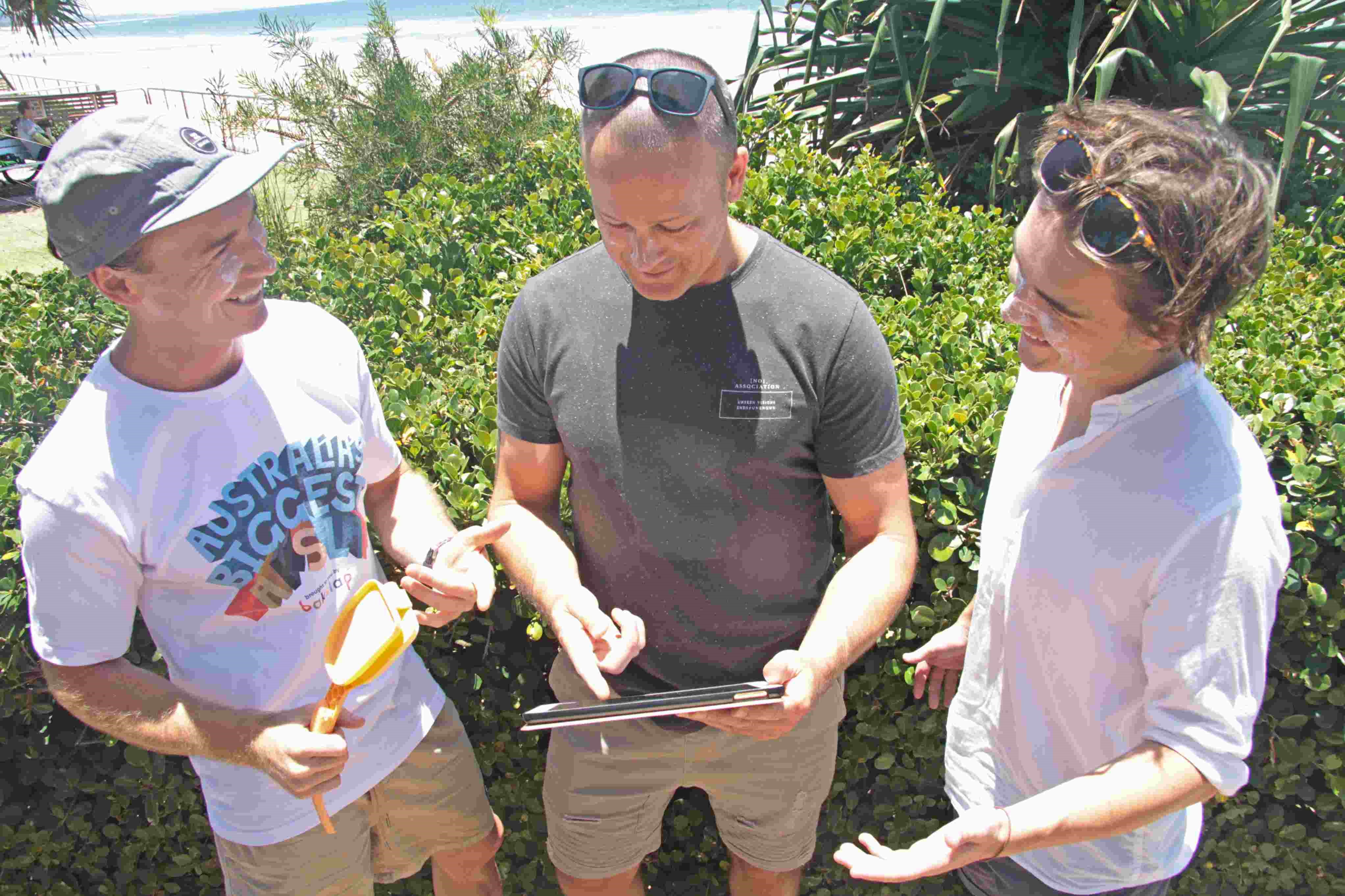 Raphael McGowan shows his brothers how the game works for bakslap sunscreen challenge